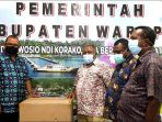 Asisten II Setda Provinsi Papua ketika menyerahkan bantuan alat kesehatan kepada Pemda Kabupaten Waropen.(Foto. Rich)