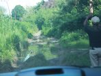 Ruas jalan Lingkar Selatan yang bertanah. Jika hujan, membuat ketakutan pengguna kendaraan pasalnya bila terperosok akan membahayakan pengemudi apalagi disekitar itu masih hutan.